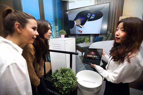 25일(현지시각) MWC 2019 KT 전시관 내 5G AI 호텔 로봇 존에서 관람객이 AI 호텔 로봇 서비스를 체험하고 있다. / KT 제공