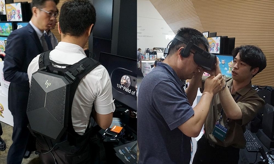 넥스트VR 참관객들이 HP의 2세대 VR백팩 시스템(왼쪽)과 2세대 VR 헤드셋 제품군을 직접 착용해보는 모습. / 최용석 기자