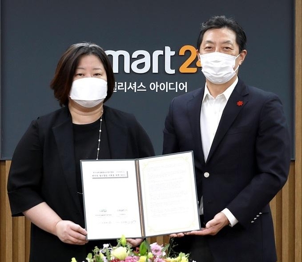 김장욱 이마트24 대표(오른쪽)와 이영애 대학학생활협동조합 이사장이 업무협약 체결후 기념촬영을 하고 있다. / 이마트24