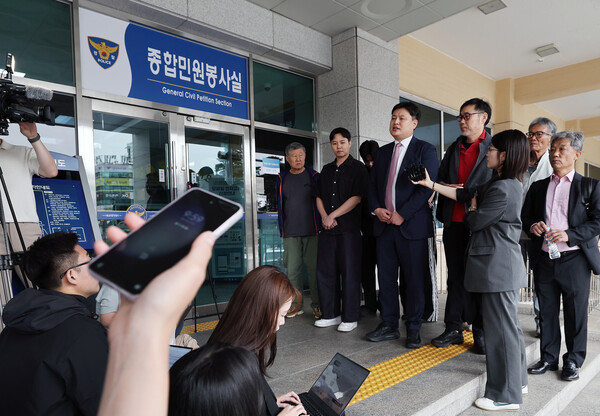 SK텔레콤(SKT) 유심 정보 해킹사고와 관련해 최태원 SK그룹 회장과 유영상 SK텔레콤 대표를 고발한 김순환 서민민생대책위원회 사무총장과 박주현 변호사가 23일 오전 서울 중구 남대문경찰서에서 열린 고발인 조사에 출석하며 해킹사태 피해자들과 함께 입장을 밝히고 있다. / 뉴스1